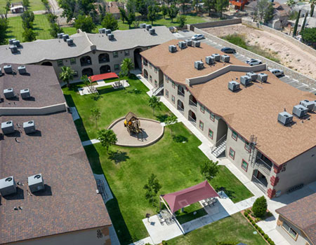 Aerial view of apartment complex with courtyard in the middle